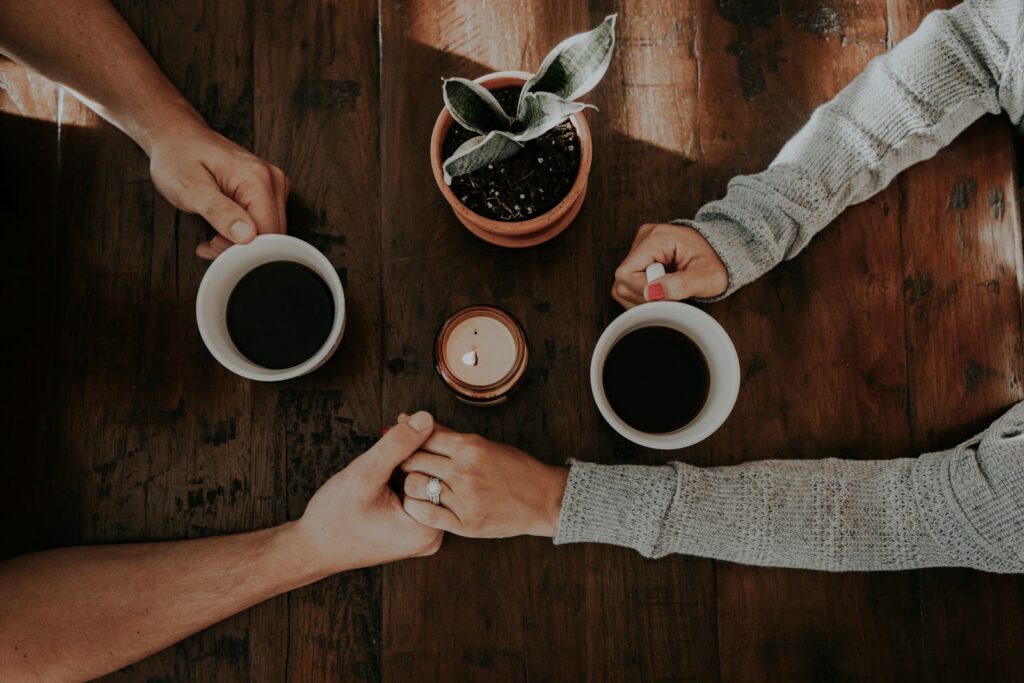 person holding white ceramic mugs for devotional It’s a Matter of the Heart